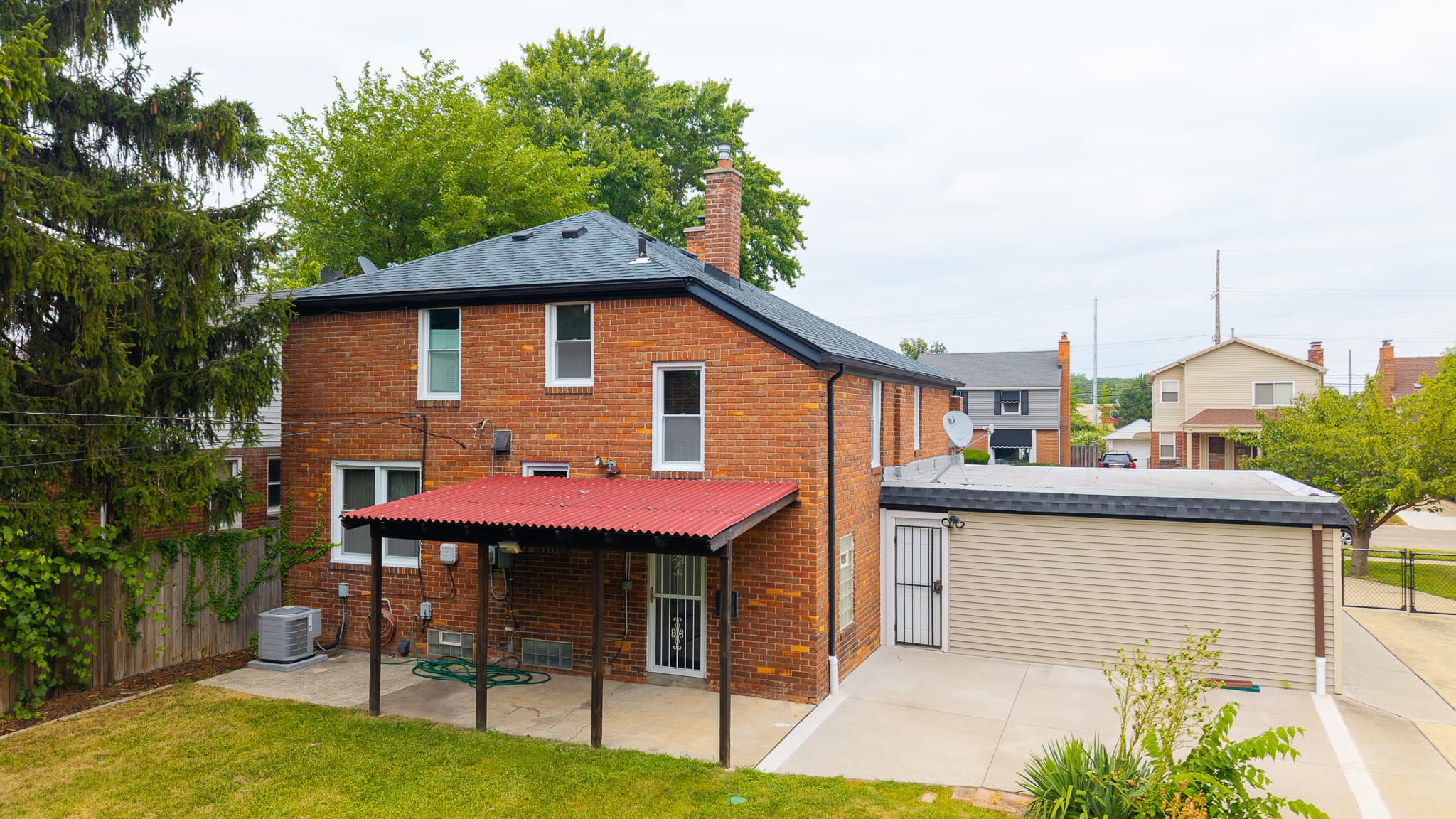 Back exterior drone shot of a Metro Detroit property
