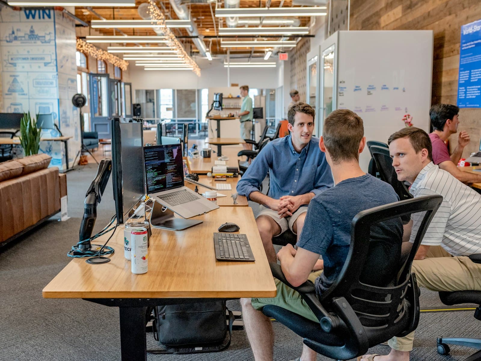 Hola Media team members collaborating at a shared desk